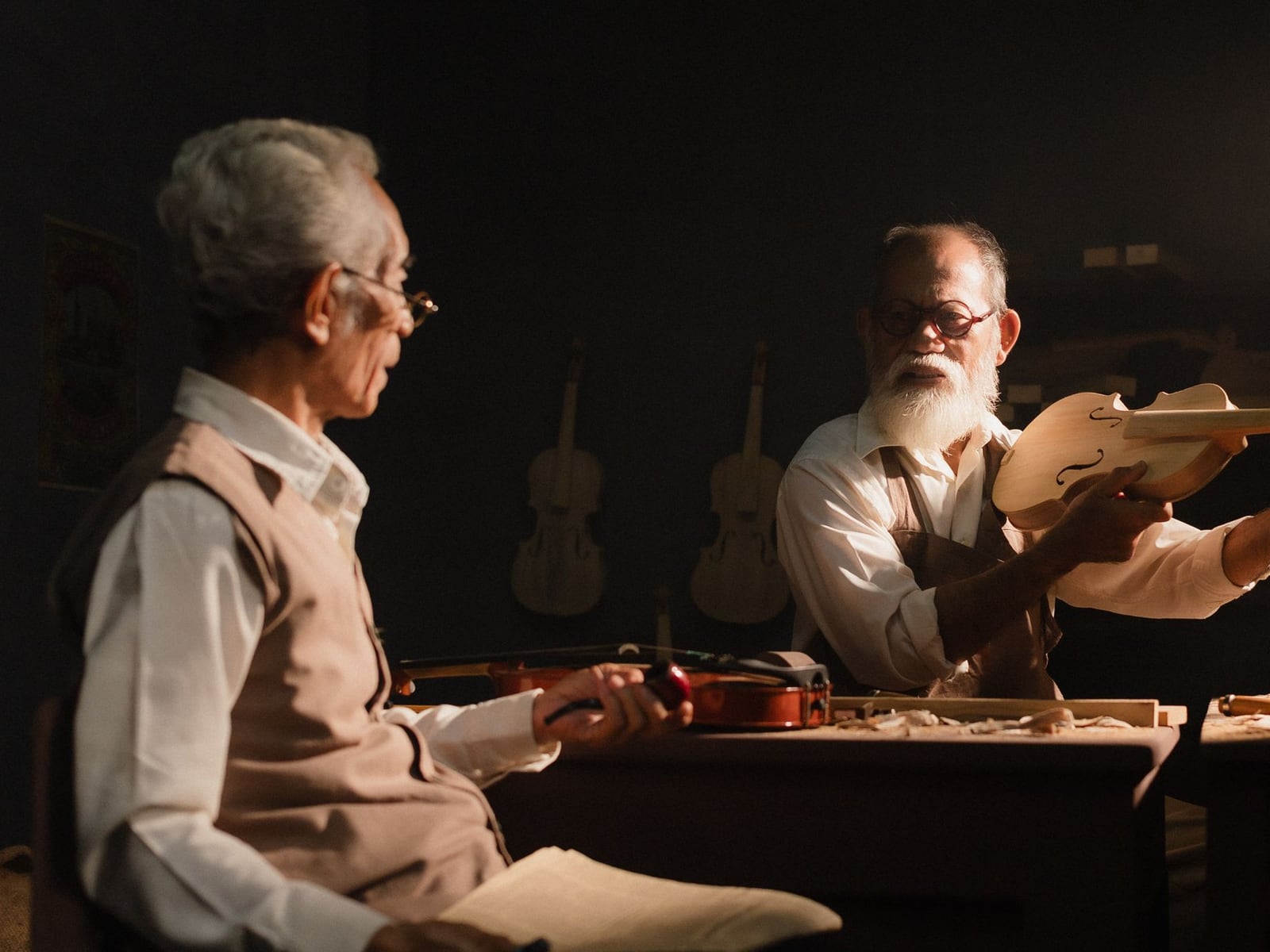 Detailed shot of a master craftsman carving a bridge for a violin from high-quality wood.