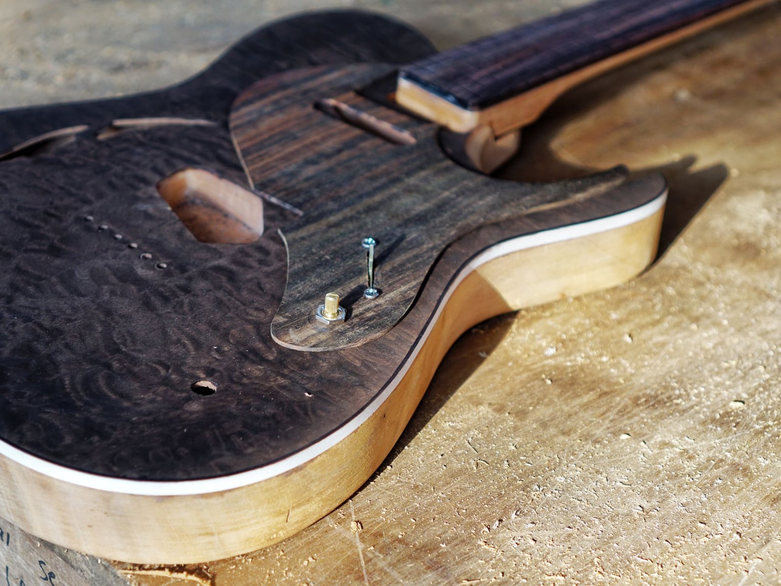 A custom-made guitar body in the early stages of construction from fine tonewoods.